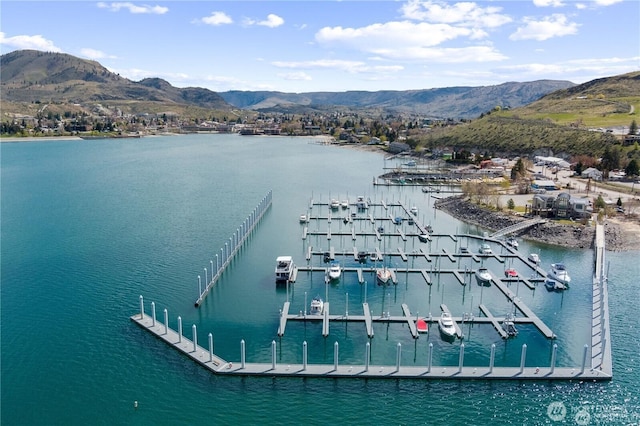 aerial view featuring a water and mountain view