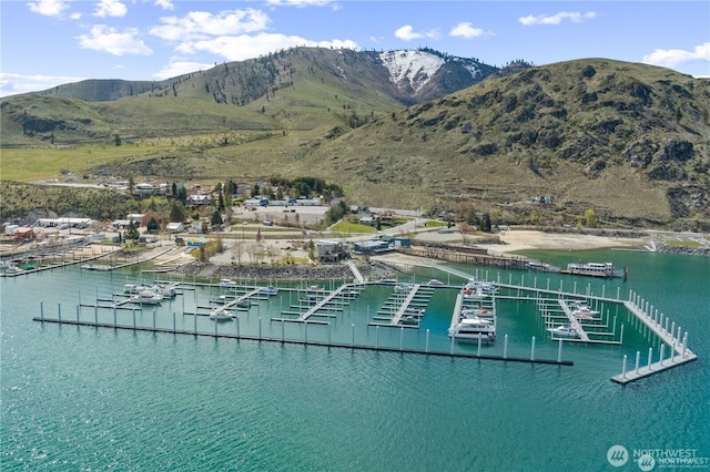 drone / aerial view with a water and mountain view