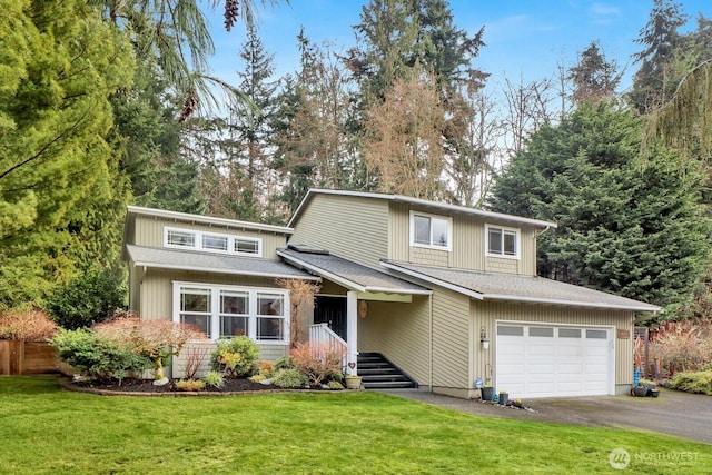 traditional home featuring aphalt driveway, a garage, a front lawn, and roof with shingles