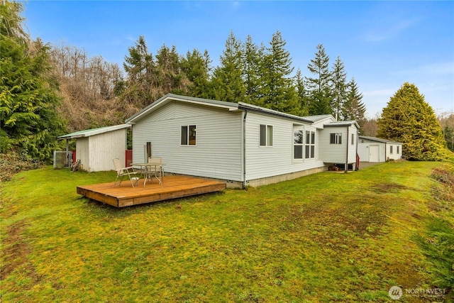 rear view of house featuring crawl space, a yard, and a deck