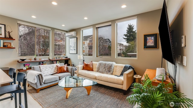 living area featuring a wall mounted AC, recessed lighting, and a healthy amount of sunlight