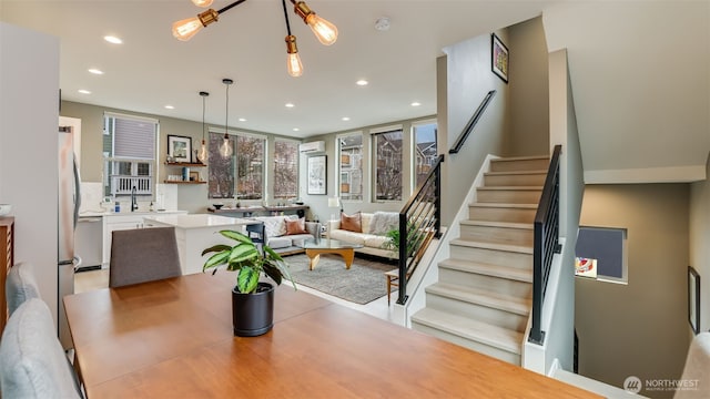 dining room with recessed lighting and stairs