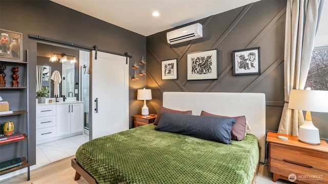 bedroom with connected bathroom, a barn door, recessed lighting, marble finish floor, and a wall mounted AC