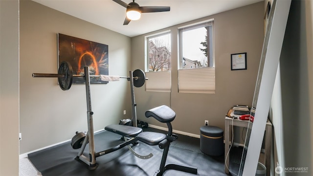 workout room with baseboards and ceiling fan