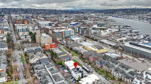 birds eye view of property featuring a water view and a view of city