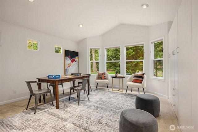 dining space with vaulted ceiling, recessed lighting, light colored carpet, and baseboards