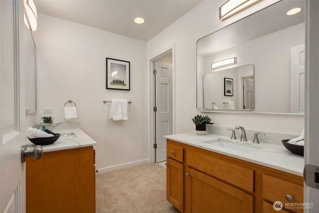 bathroom with recessed lighting, vanity, and baseboards