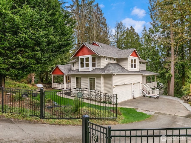 view of front of house with a fenced front yard, concrete driveway, a garage, and a shingled roof