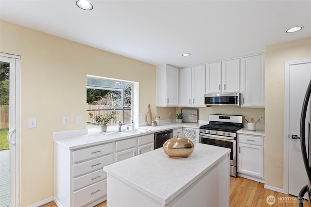 kitchen with recessed lighting, white cabinets, stainless steel appliances, and a sink