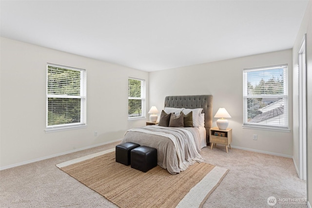 bedroom featuring multiple windows, baseboards, and light carpet