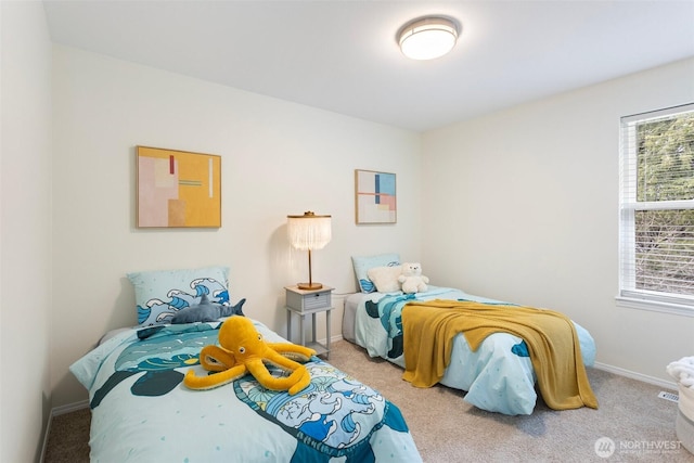 carpeted bedroom featuring baseboards