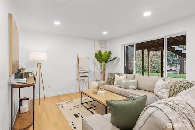 living room featuring recessed lighting, baseboards, and wood finished floors