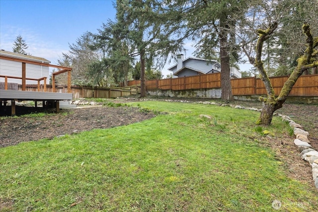 view of yard with a deck and fence