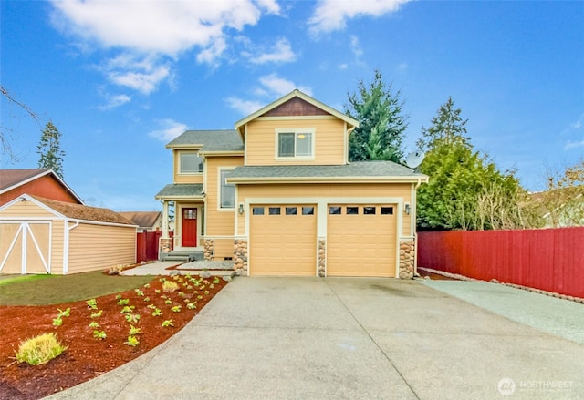 view of front of house featuring stone siding, an attached garage, concrete driveway, and fence