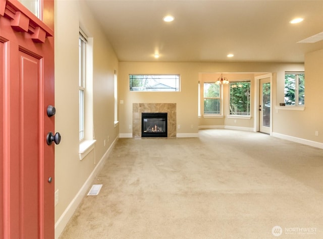 unfurnished living room featuring light carpet, visible vents, recessed lighting, and baseboards