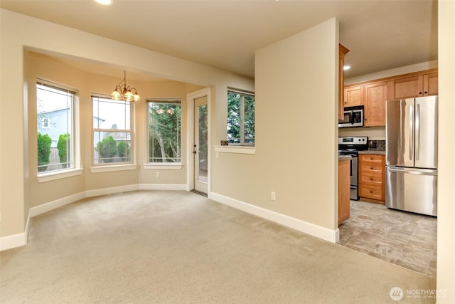 interior space with recessed lighting, baseboards, light carpet, and a chandelier