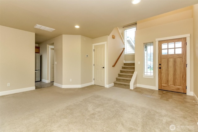 foyer featuring visible vents, baseboards, stairs, light carpet, and recessed lighting