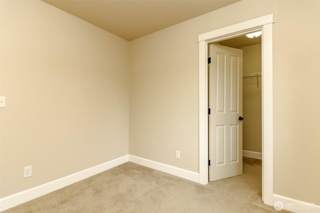 carpeted spare room with baseboards