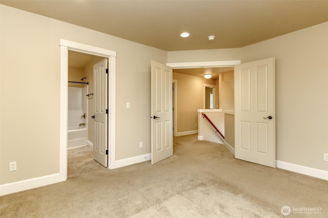 unfurnished bedroom with carpet flooring and baseboards