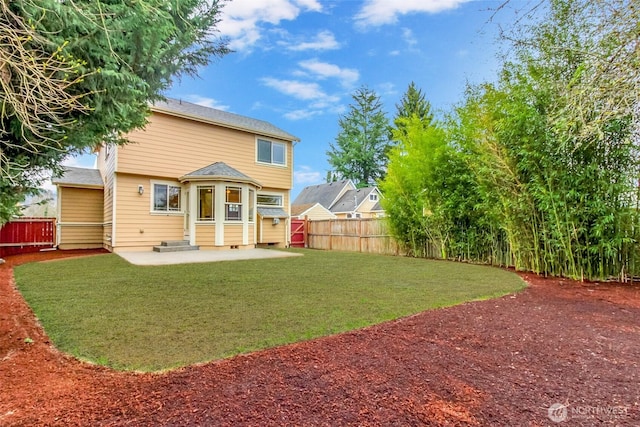 back of property with crawl space, entry steps, a lawn, a fenced backyard, and a patio area