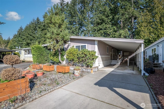 view of front of house with a carport and driveway