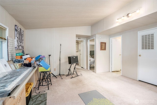 interior space featuring visible vents, lofted ceiling, and carpet