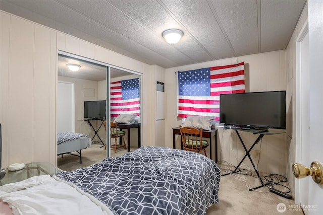 bedroom featuring a closet, a textured ceiling, and carpet flooring