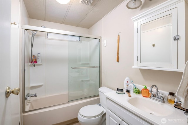 full bath with visible vents, toilet, vanity, and shower / bath combination with glass door