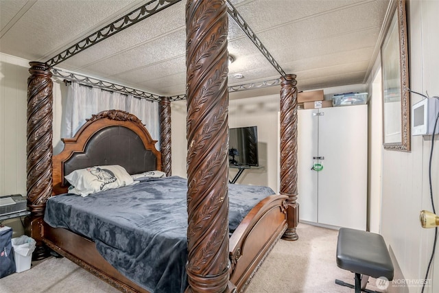 carpeted bedroom featuring wooden walls and ornate columns