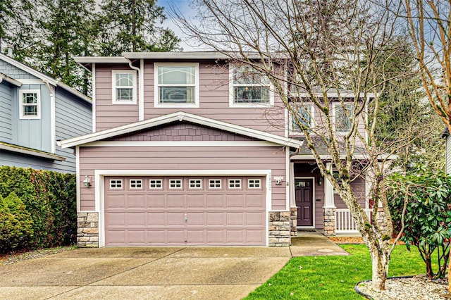 view of front of property featuring stone siding, concrete driveway, and a garage