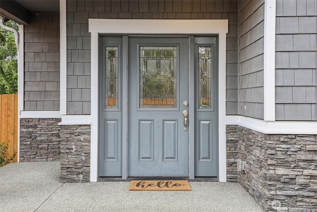 entrance to property featuring stone siding