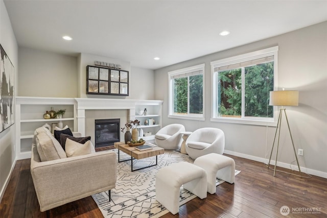 living room with a tiled fireplace, recessed lighting, baseboards, and wood-type flooring