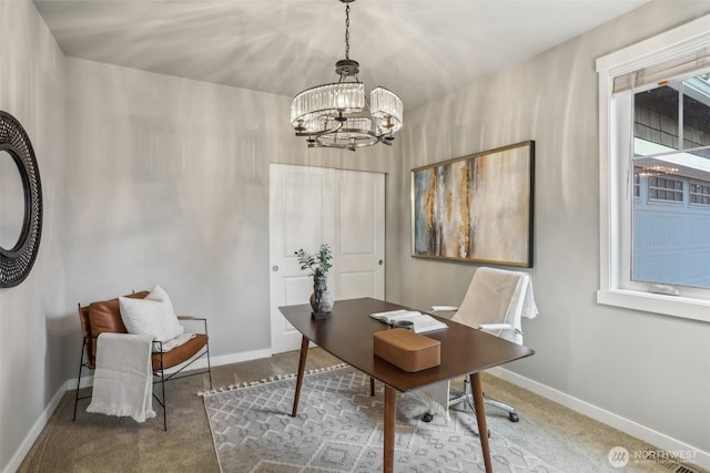 carpeted office space with baseboards and a chandelier