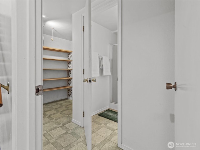 bathroom with tile patterned floors, baseboards, and a stall shower