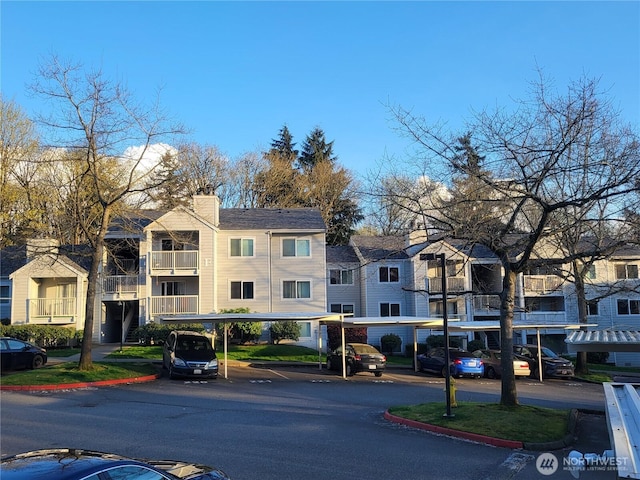 975 Aberdeen Ave NE Unit F407, Renton, WA 98056 - exterior space featuring covered and uncovered parking and a residential view