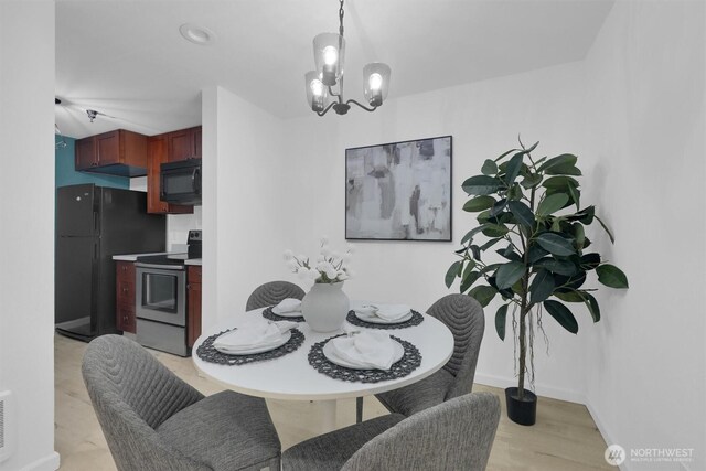 975 Aberdeen Ave NE Unit F407, Renton, WA 98056 - dining room featuring a chandelier and baseboards