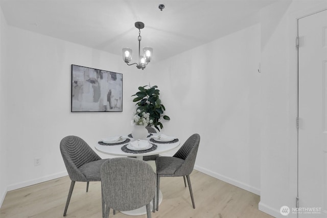 975 Aberdeen Ave NE Unit F407, Renton, WA 98056 - dining area with a chandelier, baseboards, and wood finished floors