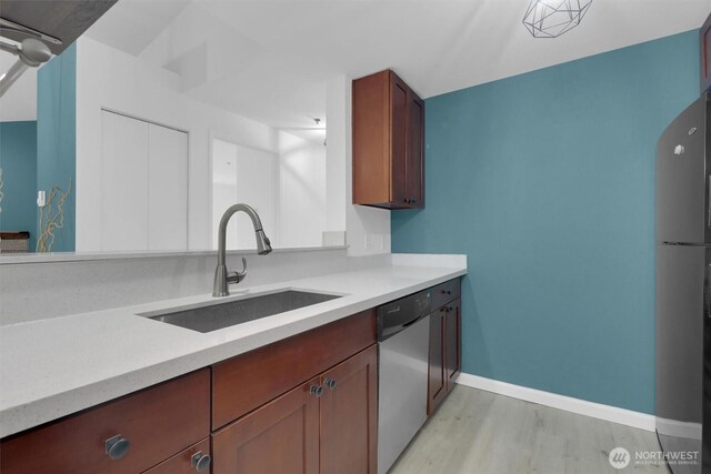 975 Aberdeen Ave NE Unit F407, Renton, WA 98056 - kitchen with appliances with stainless steel finishes, light countertops, baseboards, and a sink