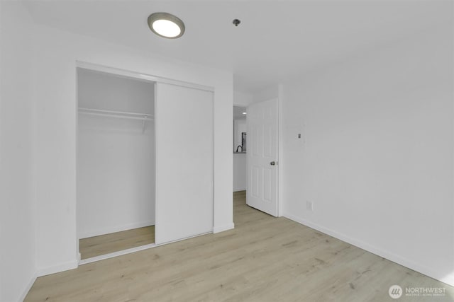 975 Aberdeen Ave NE Unit F407, Renton, WA 98056 - unfurnished bedroom with a closet, baseboards, and wood finished floors