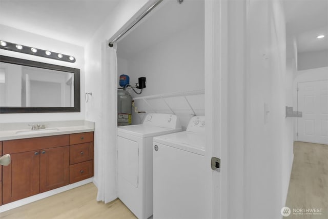 975 Aberdeen Ave NE Unit F407, Renton, WA 98056 - laundry room with a sink, light wood-style floors, washing machine and dryer, and laundry area