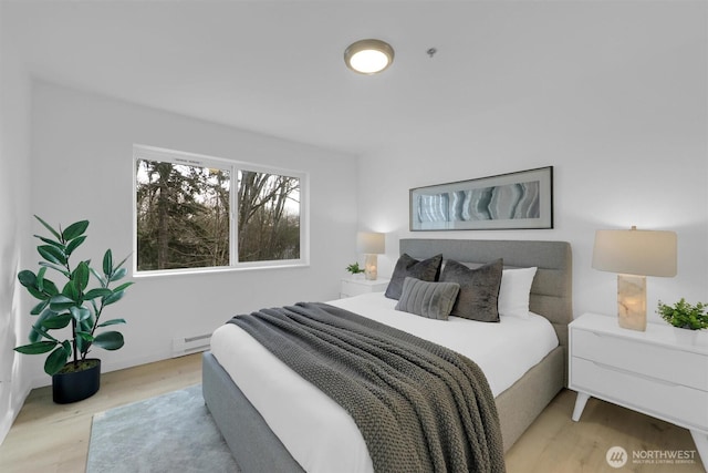 975 Aberdeen Ave NE Unit F407, Renton, WA 98056 - bedroom featuring a baseboard radiator and wood finished floors
