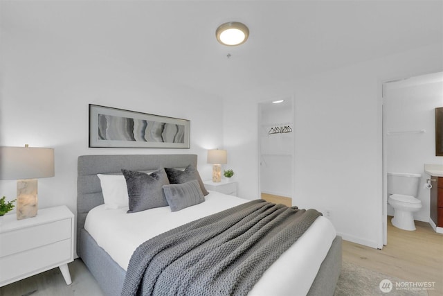 975 Aberdeen Ave NE Unit F407, Renton, WA 98056 - bedroom with baseboards, light wood-style floors, and ensuite bathroom