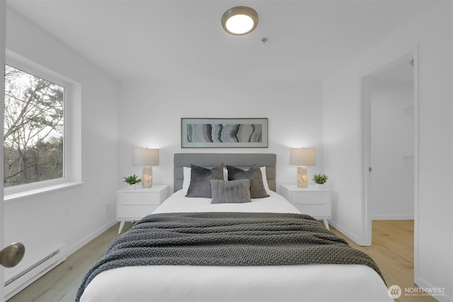 975 Aberdeen Ave NE Unit F407, Renton, WA 98056 - bedroom featuring light wood-style floors, baseboards, and baseboard heating