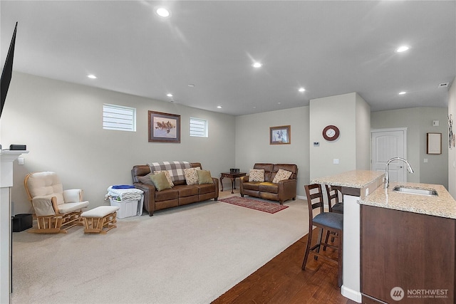 living area featuring recessed lighting and dark colored carpet