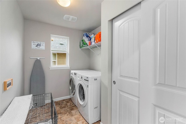 laundry area with washer and dryer, baseboards, and laundry area