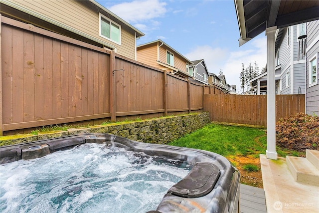 view of yard featuring a hot tub and fence