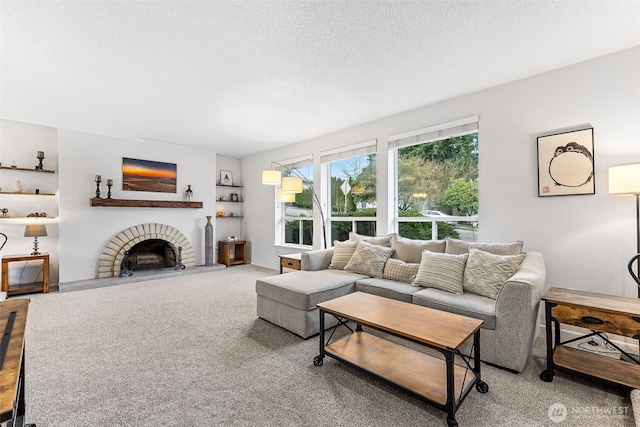 carpeted living area with a textured ceiling and a fireplace