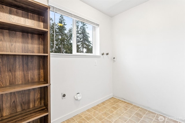 laundry room featuring laundry area, hookup for an electric dryer, and baseboards