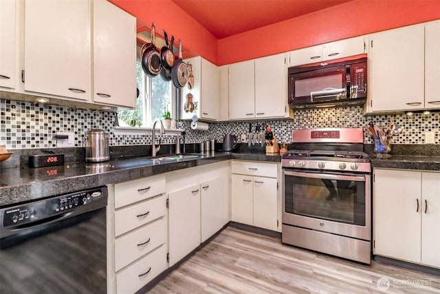 2029 S 7th St, Tacoma, WA 98405 - kitchen featuring tasteful backsplash, light wood-style flooring, white cabinets, black appliances, and a sink