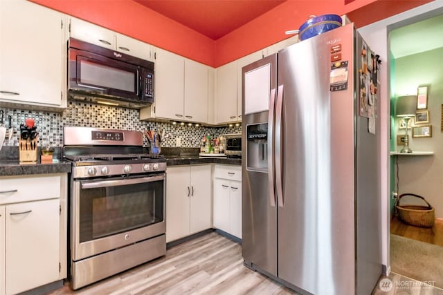 2029 S 7th St, Tacoma, WA 98405 - kitchen with backsplash, appliances with stainless steel finishes, and white cabinets
